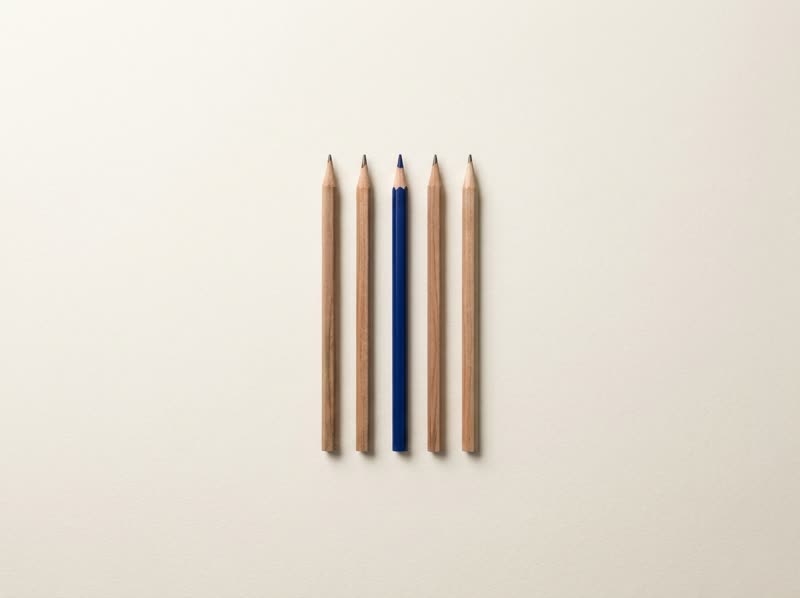 Five pencils in a neat row; one is blue.